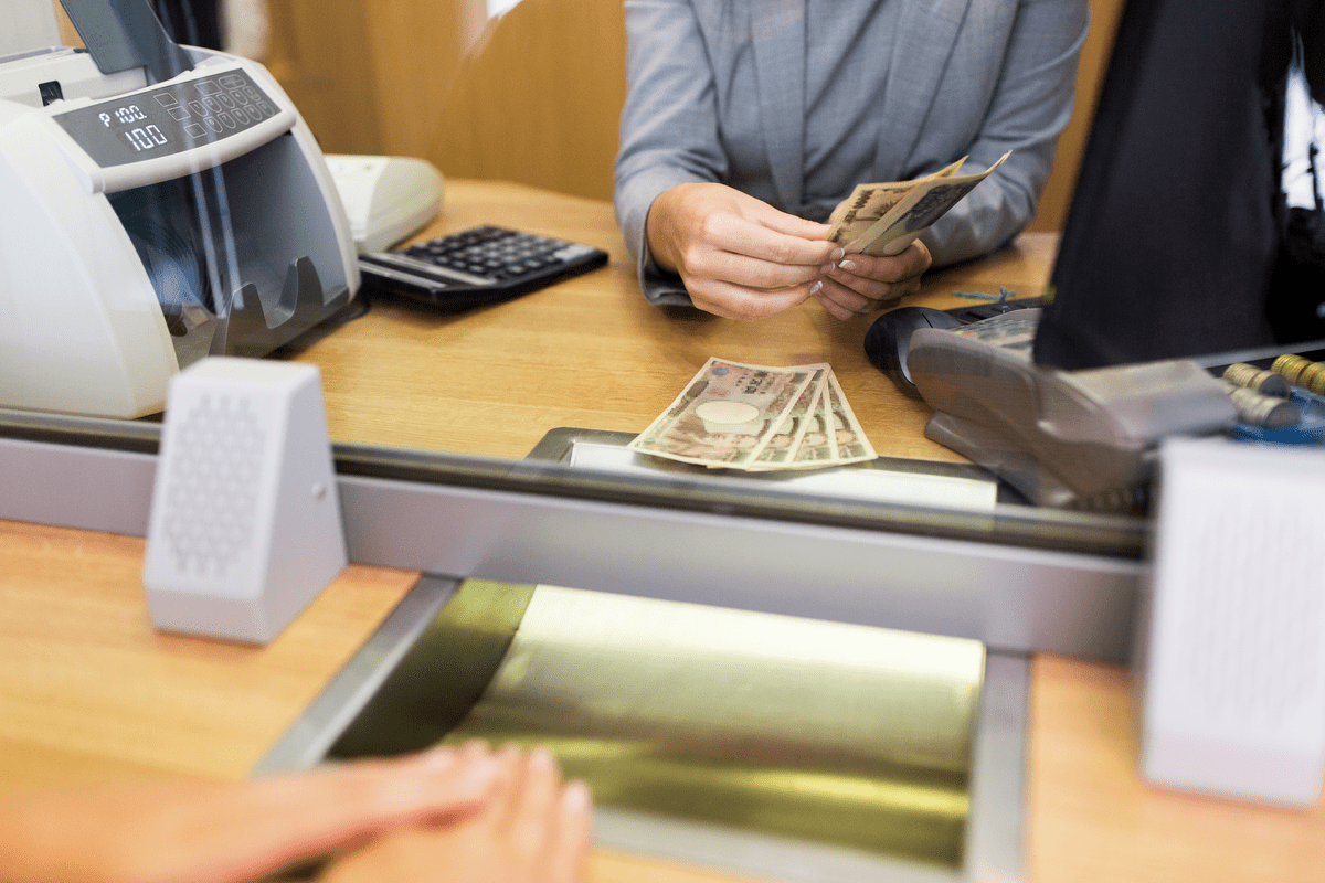 clerk counting cash money at bank office